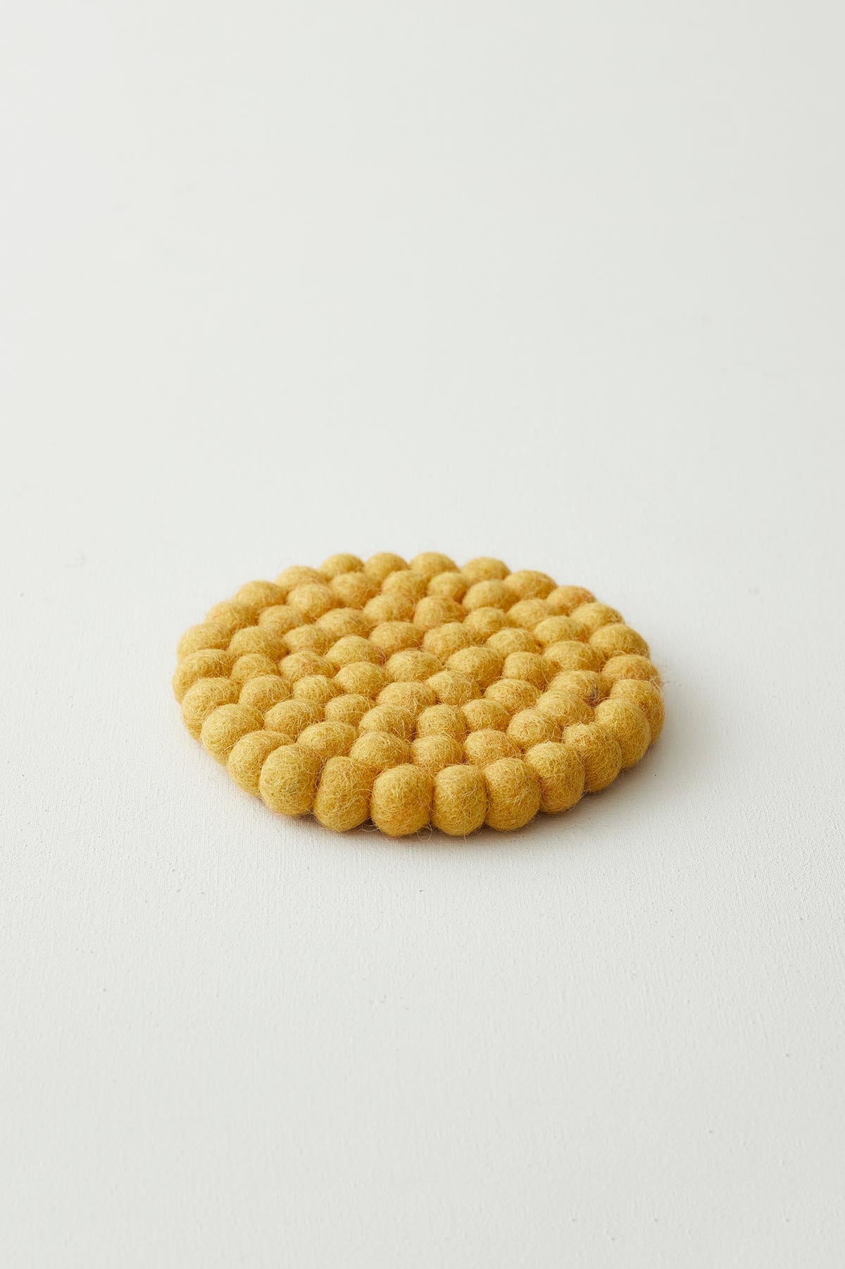 Aura Que Asik Handmade Eco Felt Ball Coaster In Yellow